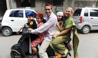 An Indian Zoroastrian or Parsi family leave a fire temple after offering prayers on Parsi New Year \'Navroze\' in Mumbai An Indian Zoroastrian or Parsi family leave a fire temple after offering prayers on Parsi New Year \'Navroze\' in Mumbai