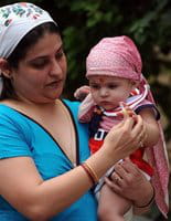 An Indian Zoroastrian or Parsi woman gives a sweet to a child in Mumbai in August An Indian Zoroastrian or Parsi woman gives a sweet to a child in Mumbai in August